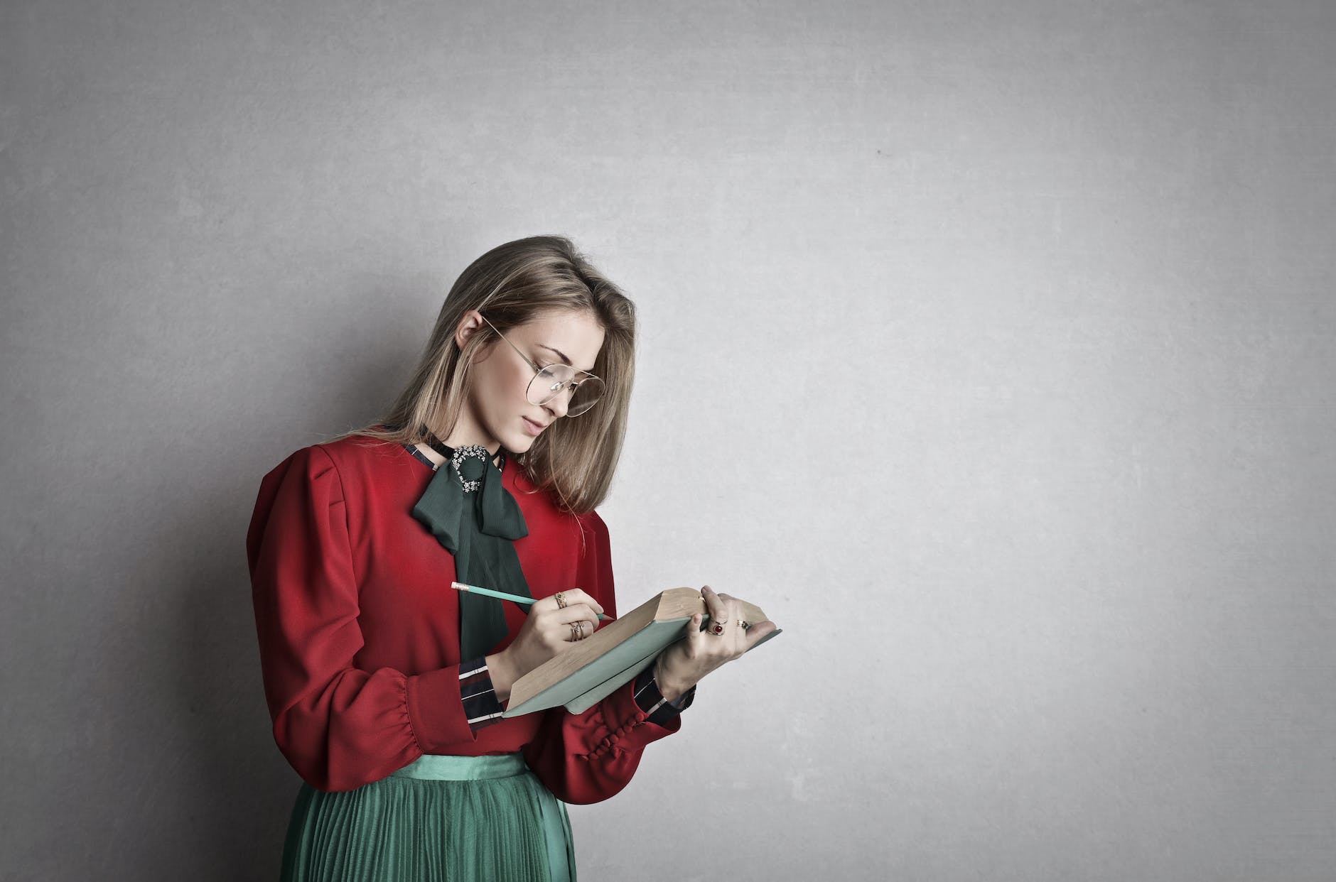 smart adult female student reading book in studio